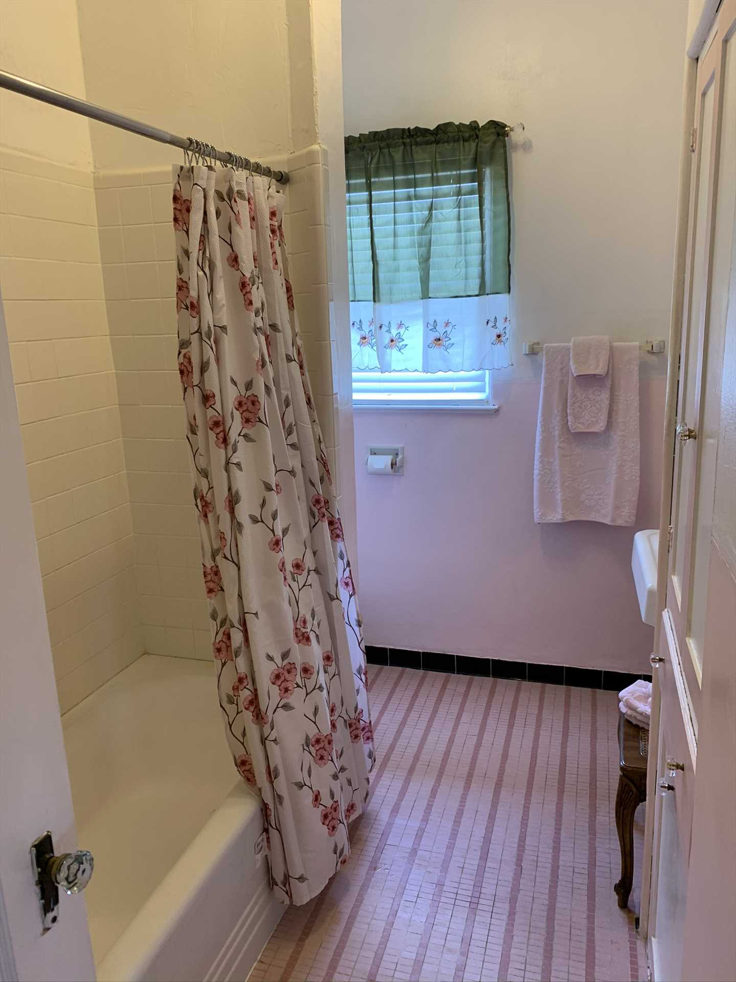                                                 A convenient shower and tub combo can be found in the third upstairs bathroom. As you can see, there's tons of cleanup space for everyone!