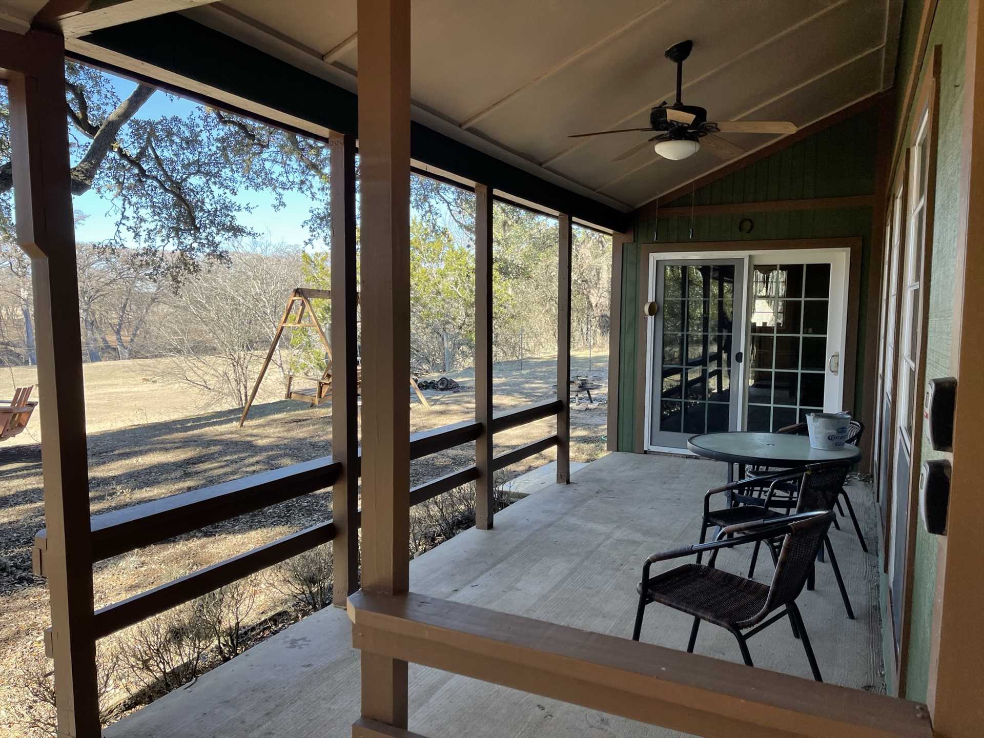                                                Porch swings and the shaded deck face the river, creating an intimate and peaceful setting.