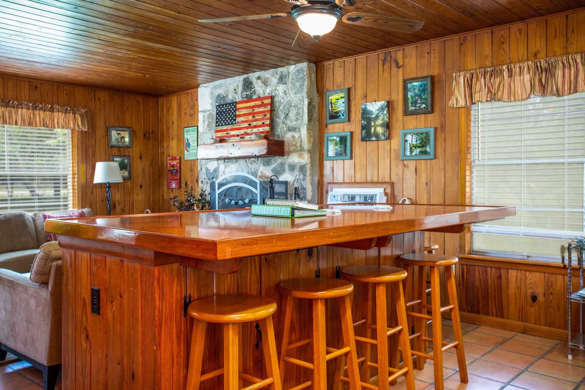                                                 The unique island bar in the kitchen not only provides plenty of food prep space, but includes bar-style seating for up to ten!