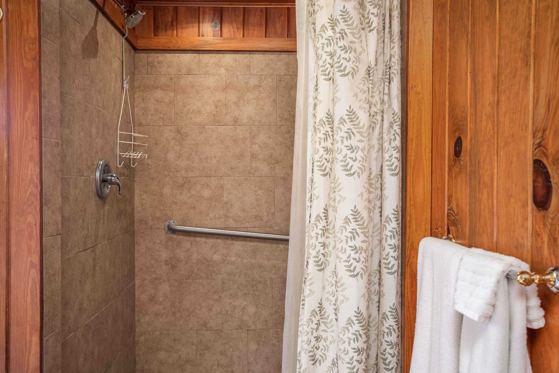                                                 A spacious tiled shower provides a perfect cleanup space in the second full bath.
