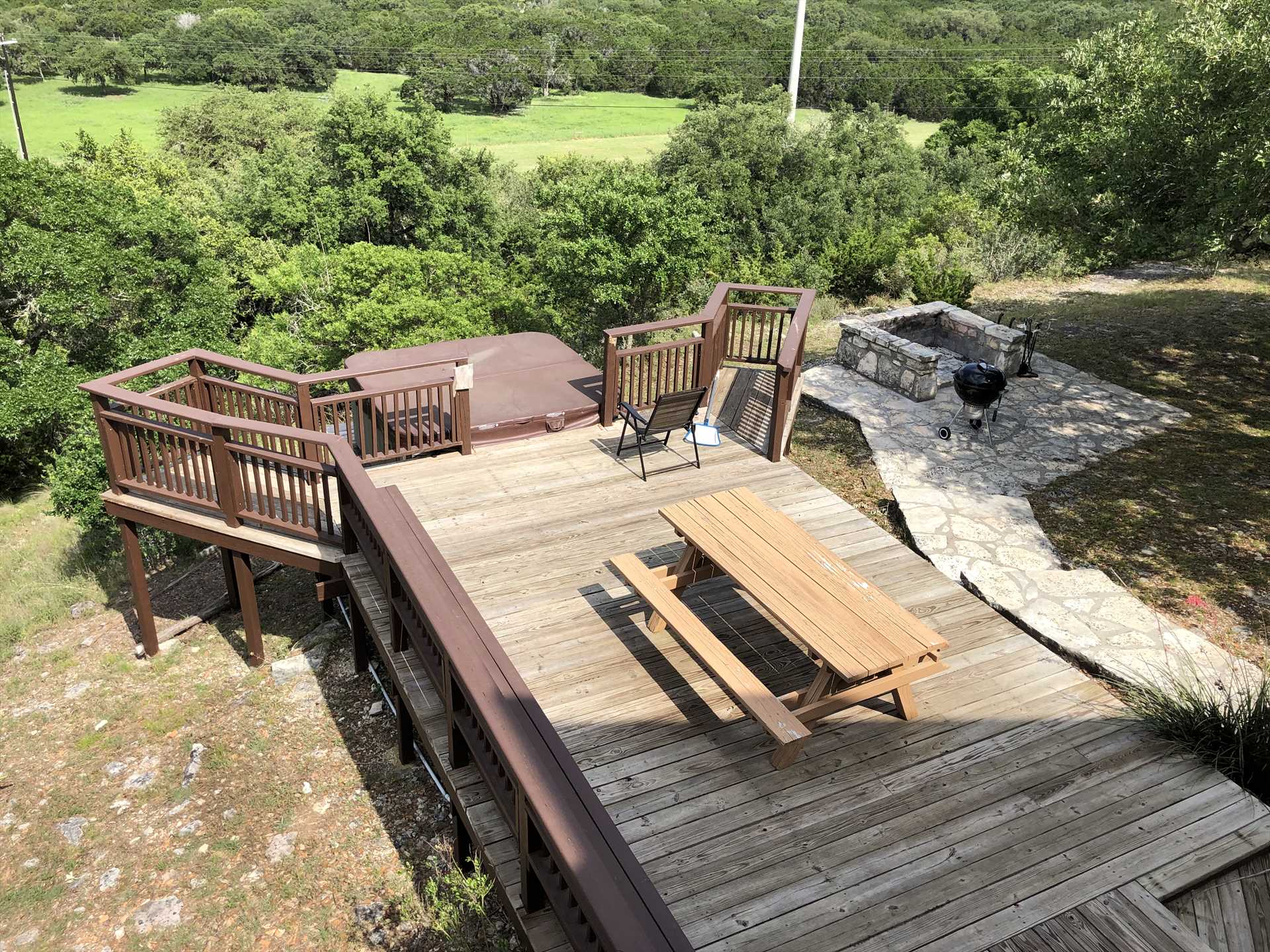                                                 Let's see...fire pit, charcoal grill, plenty of seating, a hot tub, and eye-popping Hill Country views. You may never want to leave the deck!
