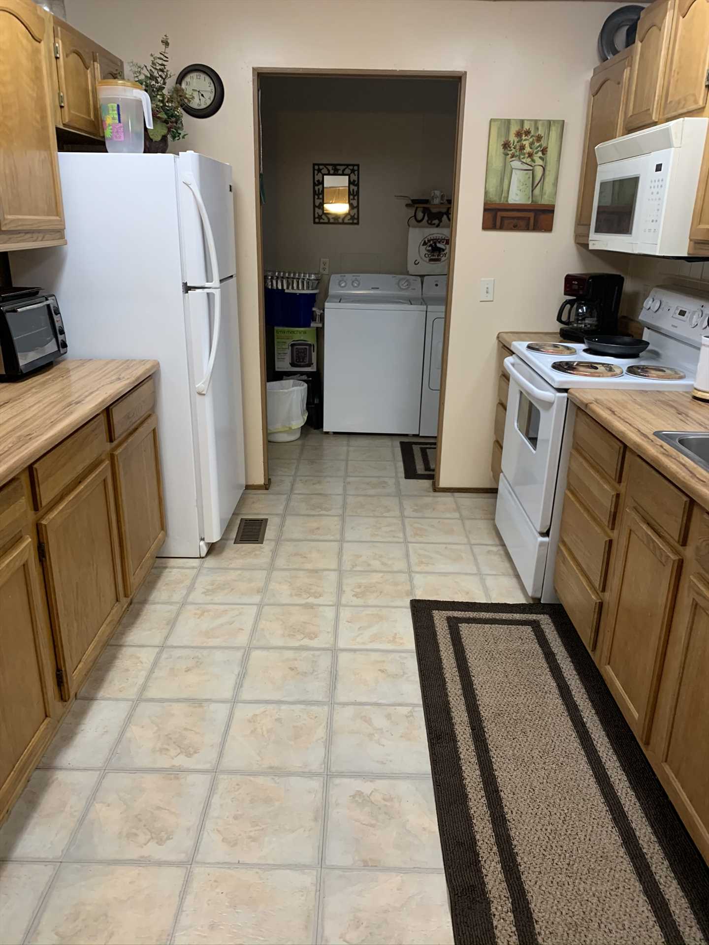                                                 Beyond the fully decked-out kitchen, you'll also find a convenient utility room, complete with a washer and dryer!
