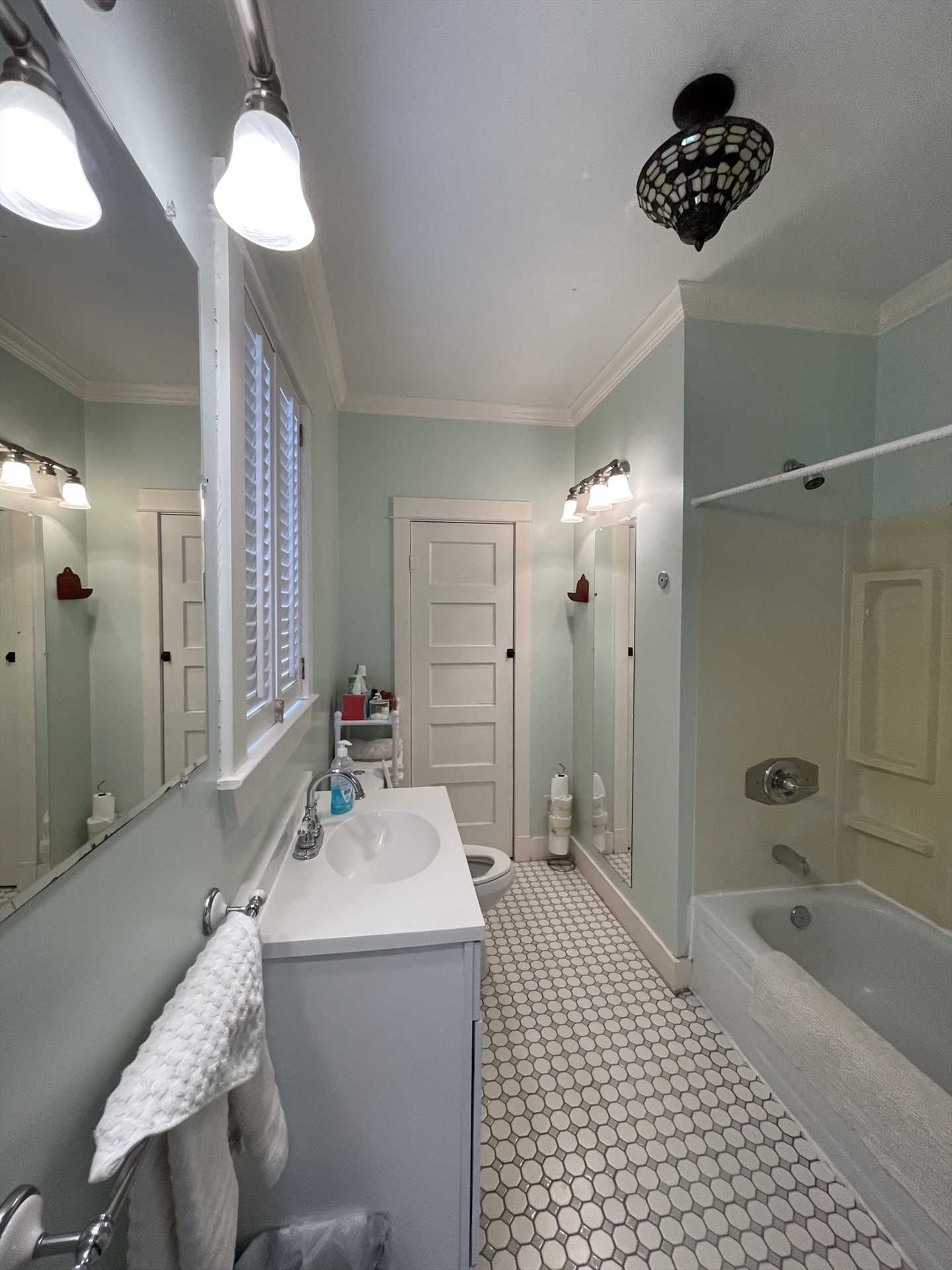                                                 Bright, airy, and spotlessly clean, the bathroom includes a tub and shower combo. Fresh bath linens are also provided.