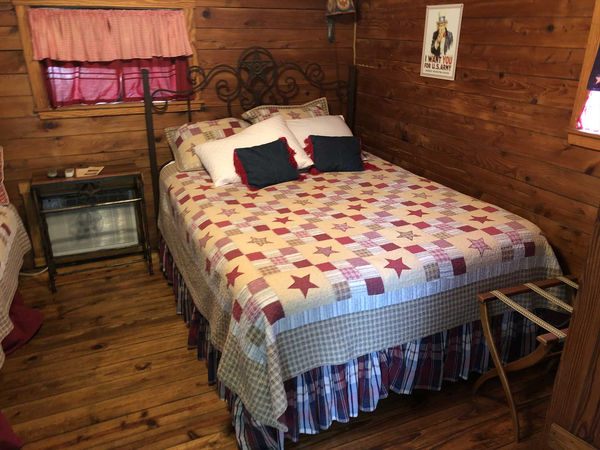                                                 Star-spangled decor and warm, clean linens make the queen bed in the Patriot Cabin a unique and comfy place to rest your head.