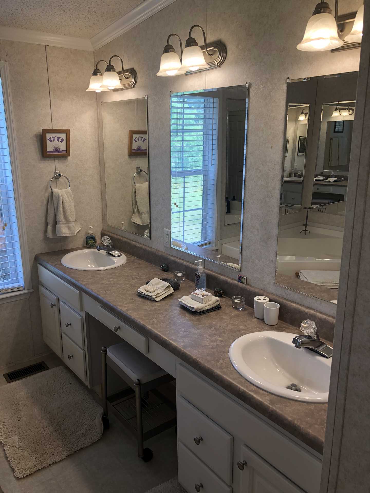                                                 Twin mirrored vanities, tons of counter space, and a generous supply of clean bath linens round out what you'll find in the master bath.