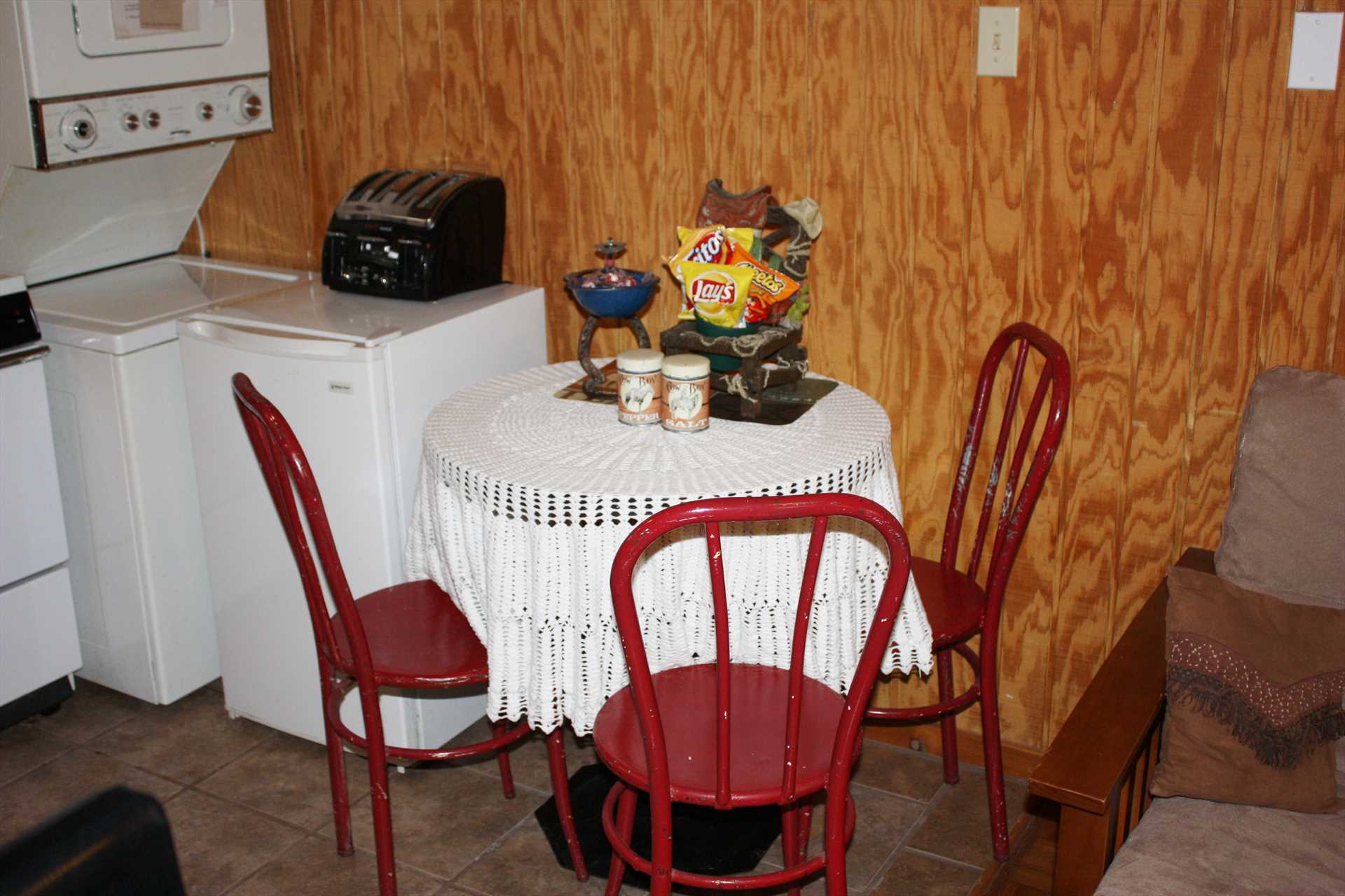                                                 The kitchen includes a cozy dining nook, and for your convenience the cabin is also furnished with a stacked washer and dryer combo.