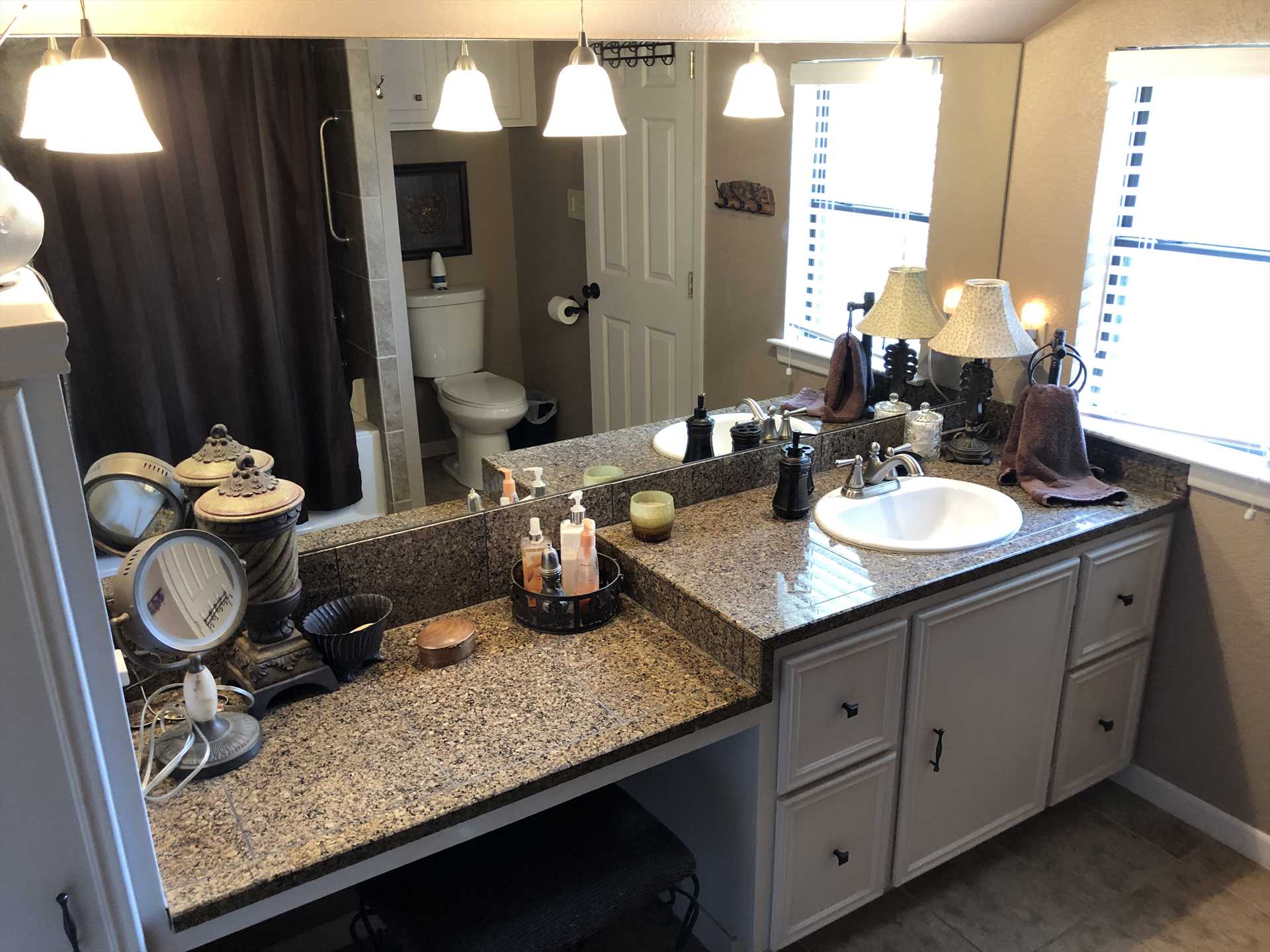                                                 The master bath includes a roomy mirrored vanity and tub and shower combo. Clean bath linens are provided for guests throughout the house, too.