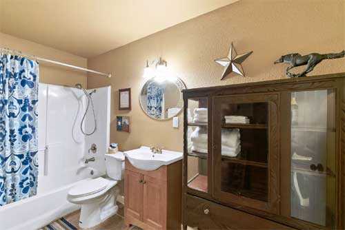                                                 Genuine Texas touches can even be found in the full bath, as well as a shower and tub combo.