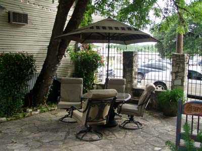                                                 Comfy swivel chairs surround the table on the shaded outdoor patio!