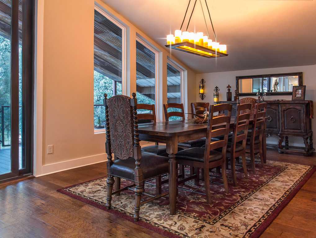                                                 Natural light, beautiful wood furnishings, and a chandelier make every meal in the dining area a special event.