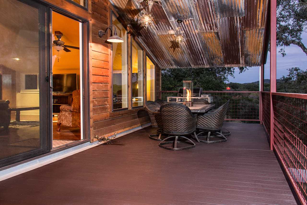                                                 Tree house-like views of the gorgeous Hill Country are yours to enjoy from the elevated second-story deck!