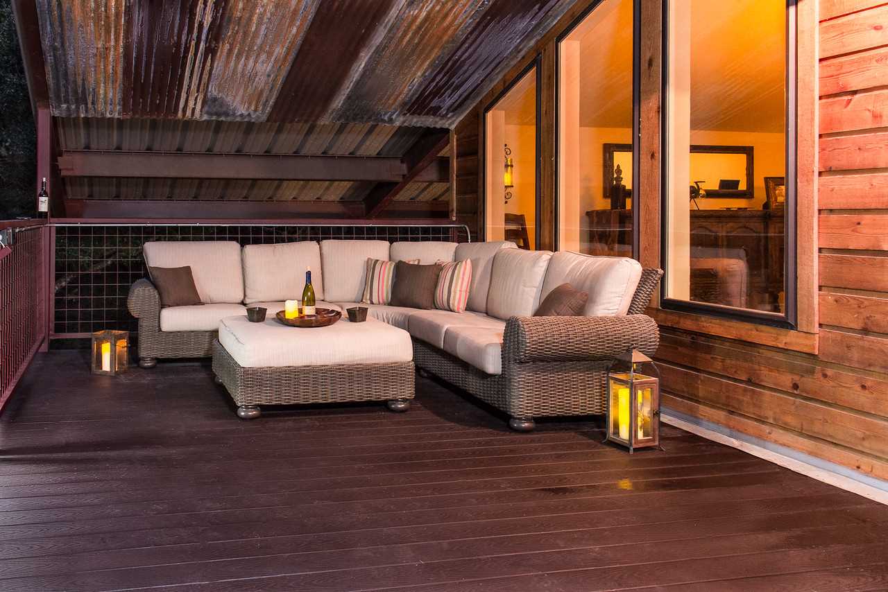                                                 The spacious back deck is outfitted just as nicely as a living room! Relax in comfort and enjoy the breezes and Hill Country views.