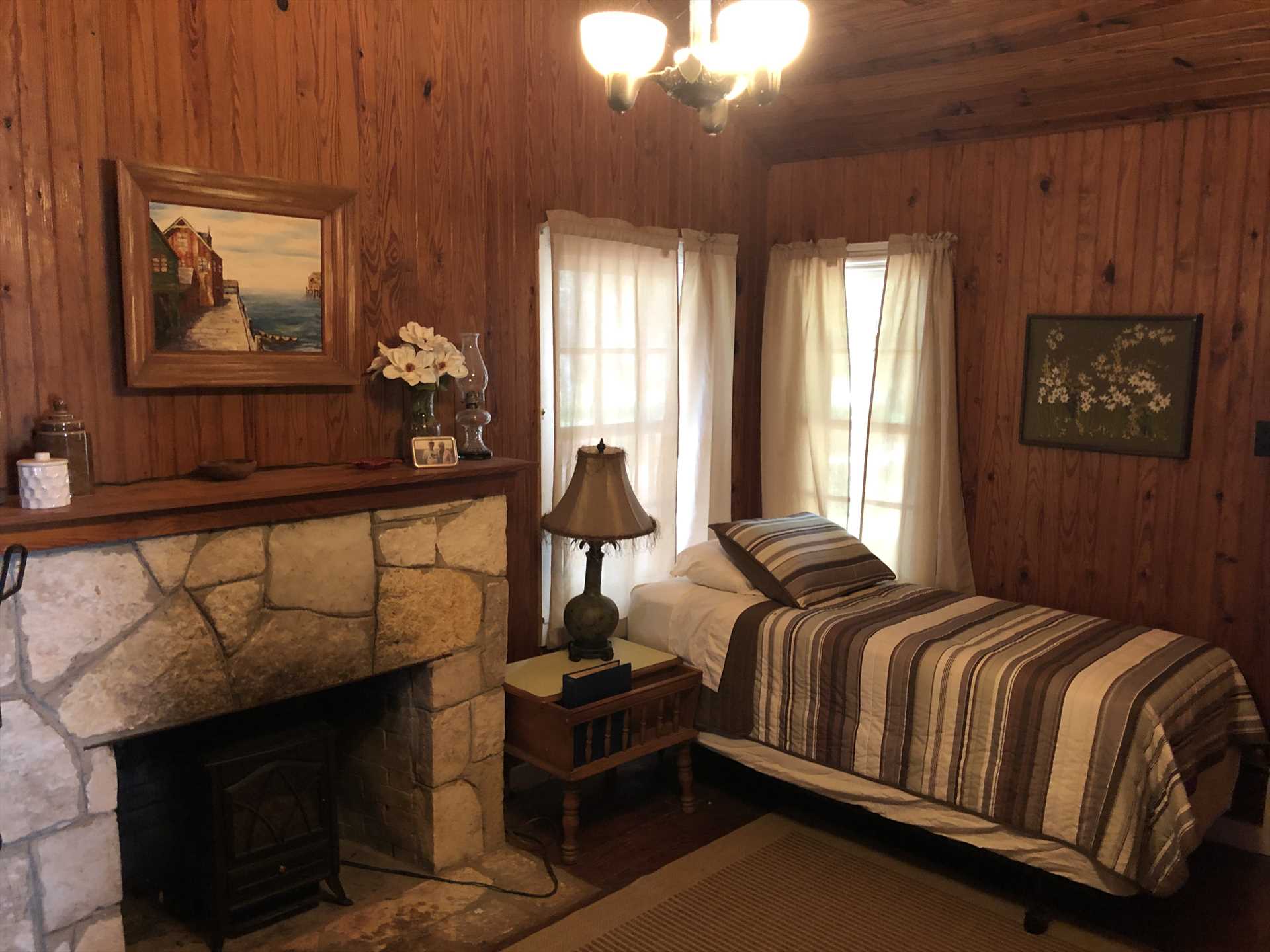                                                 The twin bed in the den is close to the electric fireplace-a great place to warm your toes on chilly nights!
