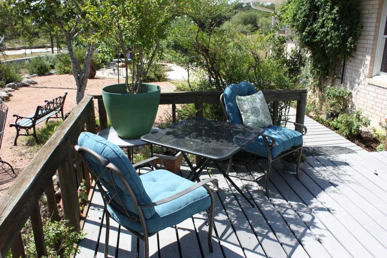                                                 There's plenty of comfy outdoor seating, fresh air, and amazing Hill Country views available on the roomy deck out back!