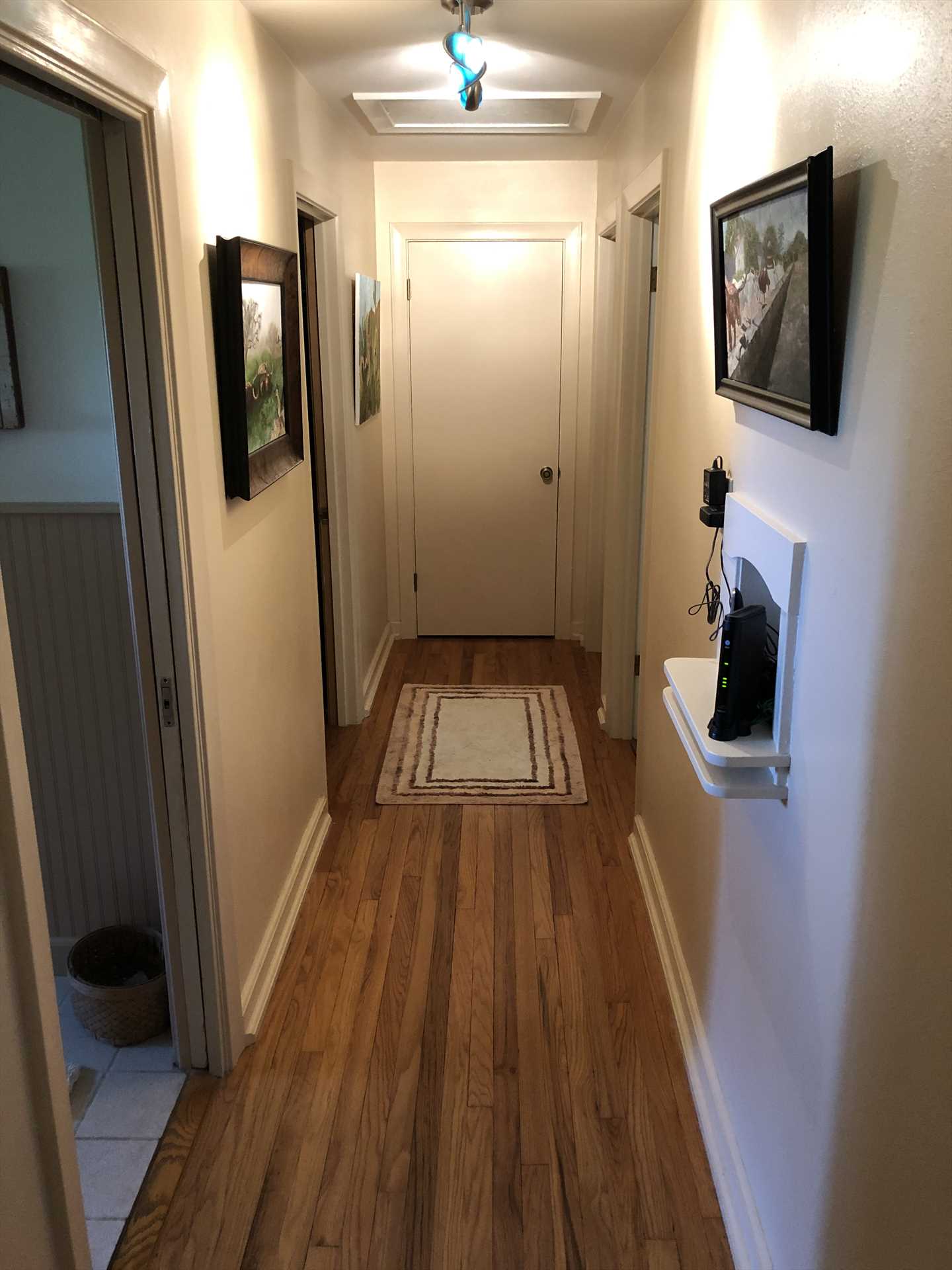                                                 Some may just see a hallway, but we see rich woodwork, framed pictures, and an area rug-special extras you won't find just anywhere!