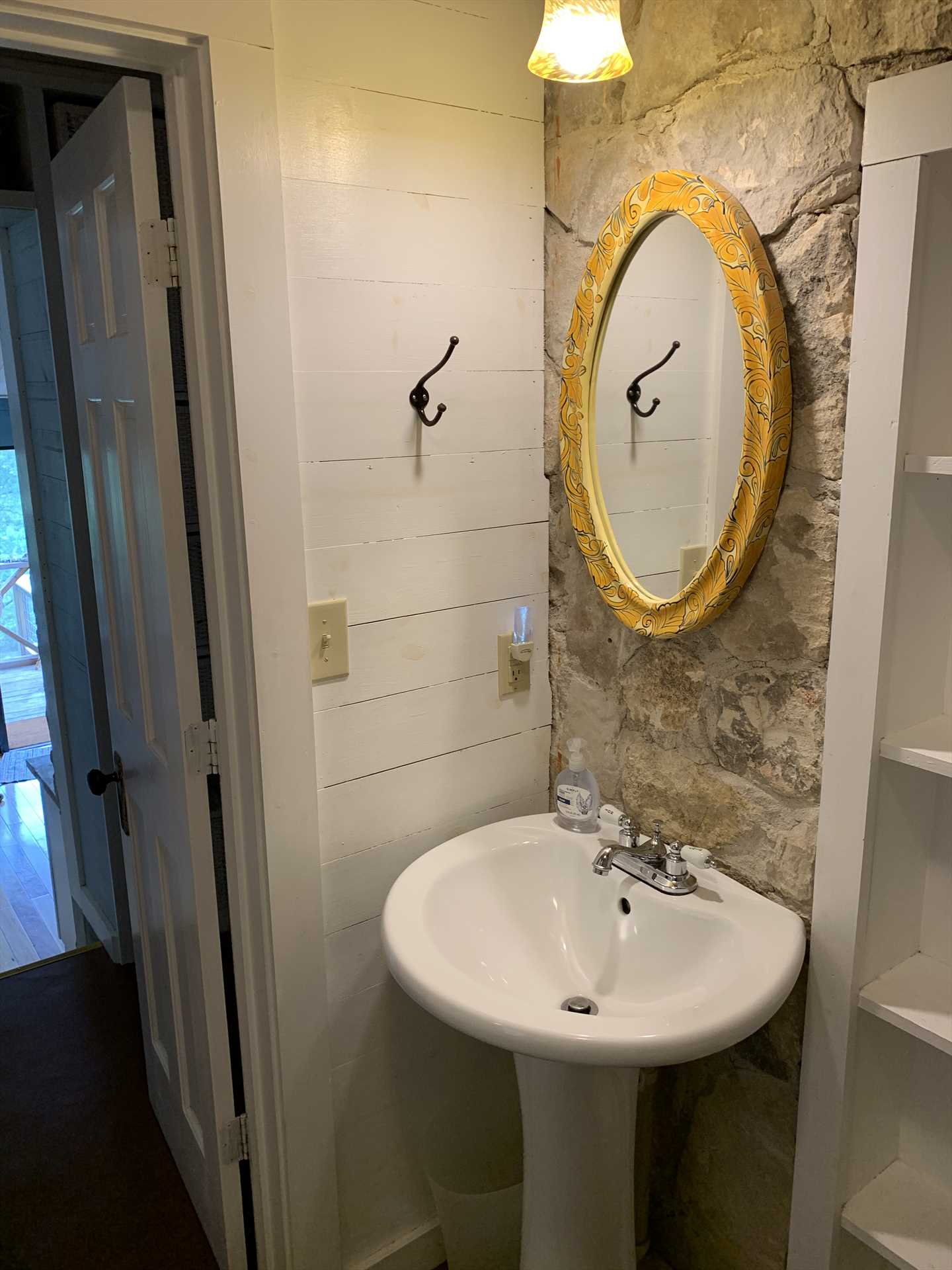                                                 The stone wall and pedestal-style vanity are just two examples of the unique touches throughout the retreat.