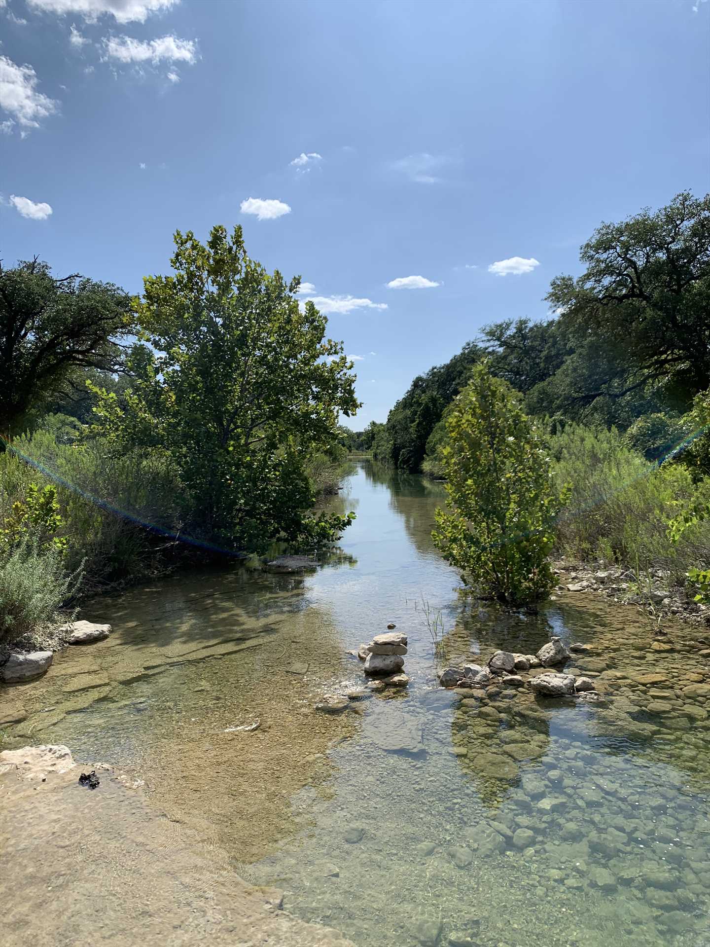                                                 Feel free to hike the 16 acres of property here, including the peaceful banks of a bubbling creek.