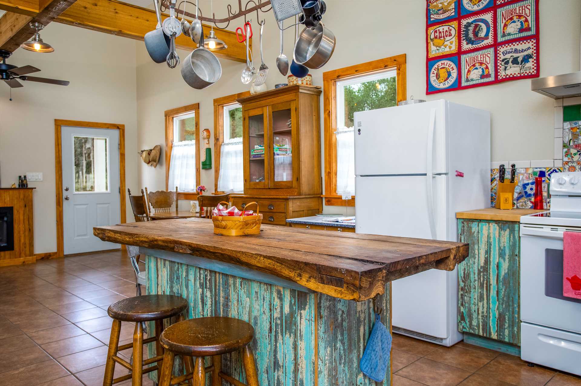                                                 Visitors here love the whimsical and rustic sky-blue barnboard highlights in the kitchen area!