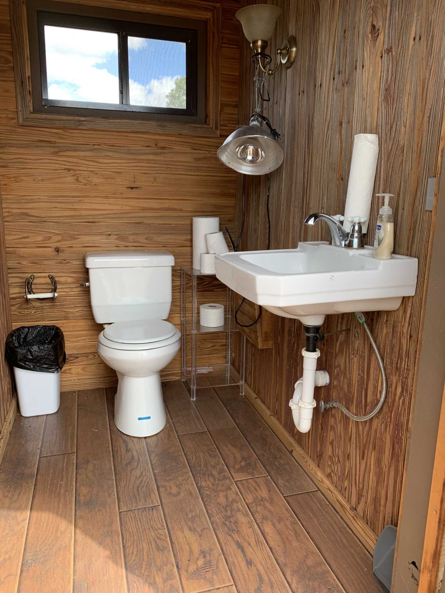                                                 A shared outhouse (with modern updates, of course) is on the grounds for guests who don't necessarily want to return to their cabins.