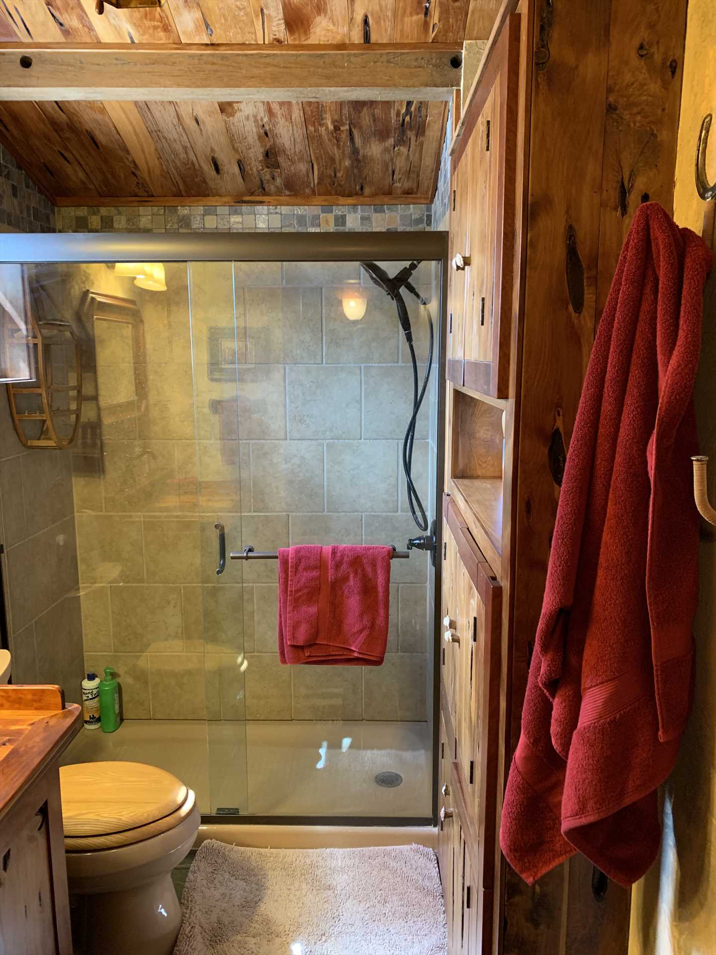                                                 The warm, wood-highlighted theme of the cabin continues in the full bath, which ix kept neat as a pin.