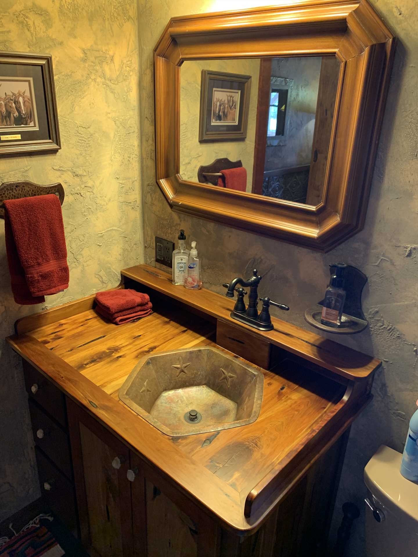                                                 Unique woodwork and geometric furnishings make even the bathroom at the Antler Cabin stand out!