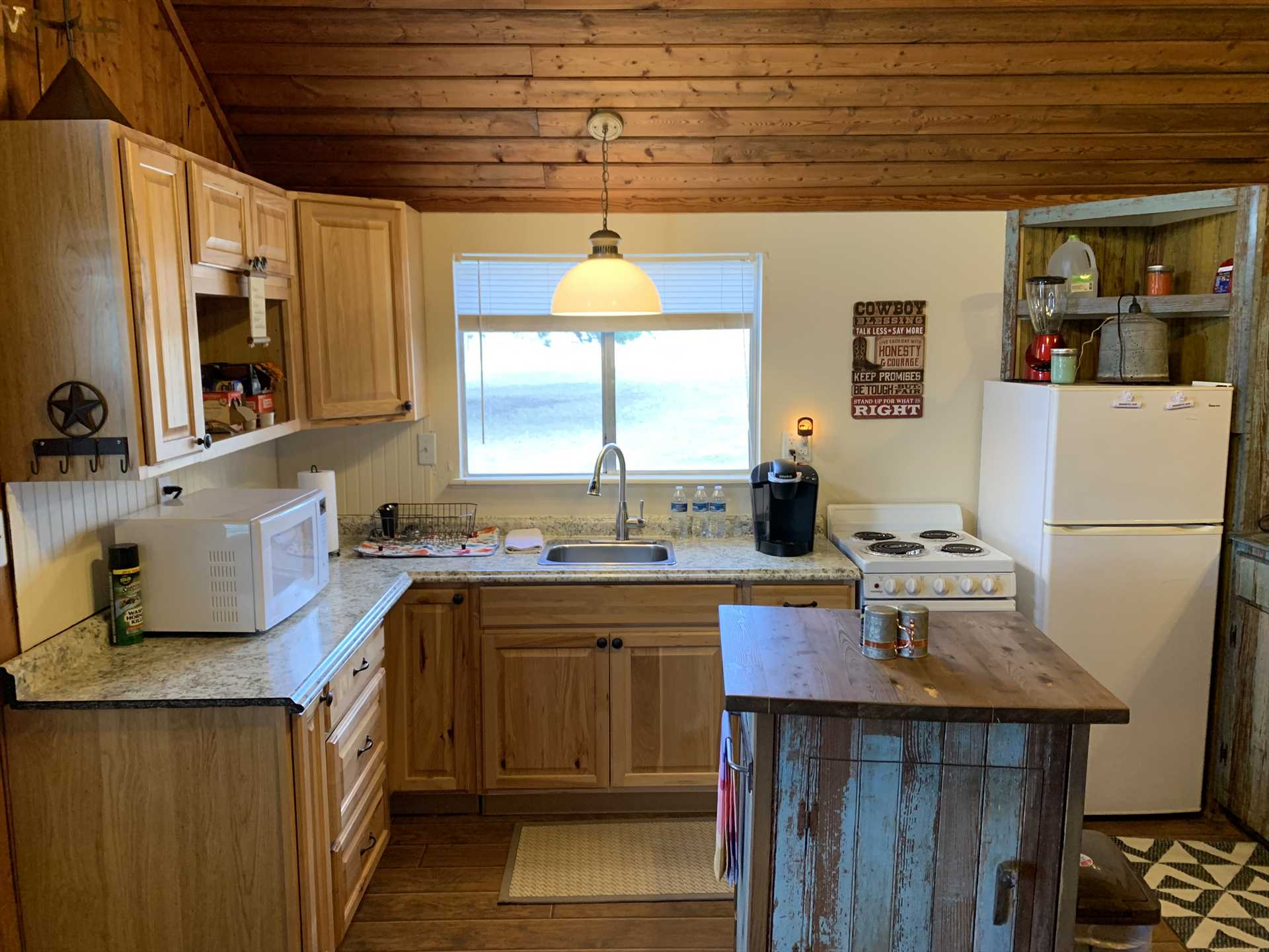                                                 The handsomely-detailed Pony Cabin kitchen includes plenty of counter space and a food prep island.
