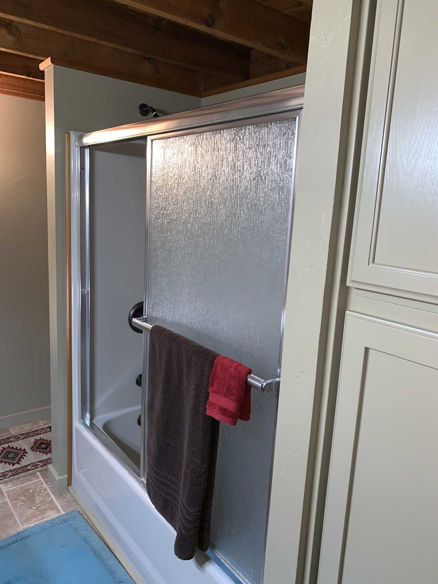                                                 A clean and modern tub and shower combo make cleanup a pleasure!