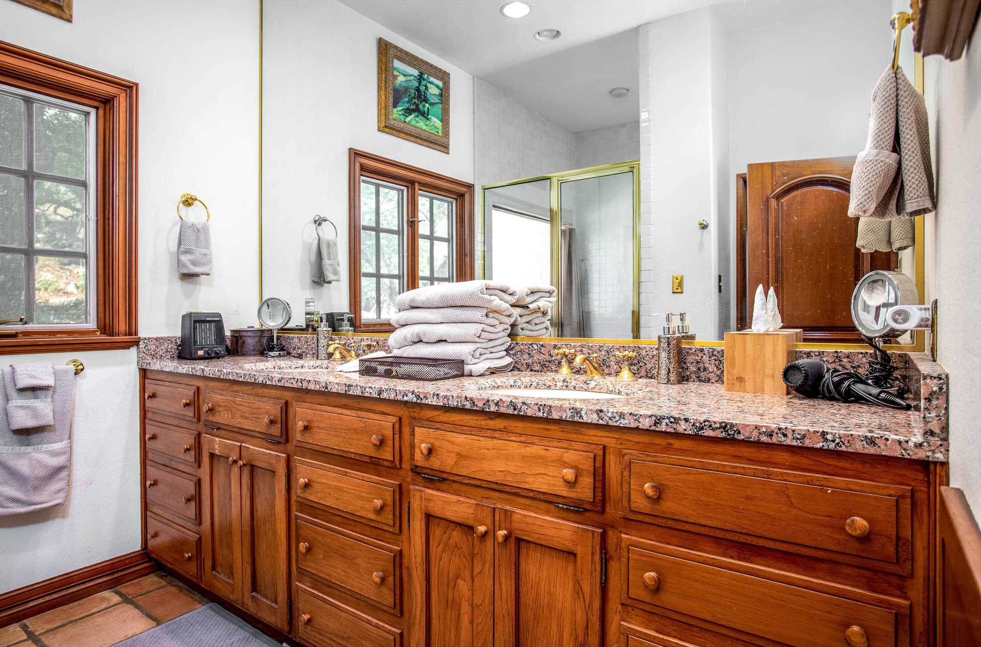                                                 A roomy double vanity with plenty of toiletry space is installed in the full bath at the Homestead, and all cleanup spaces come with essential toiletries and clean linens, as well.