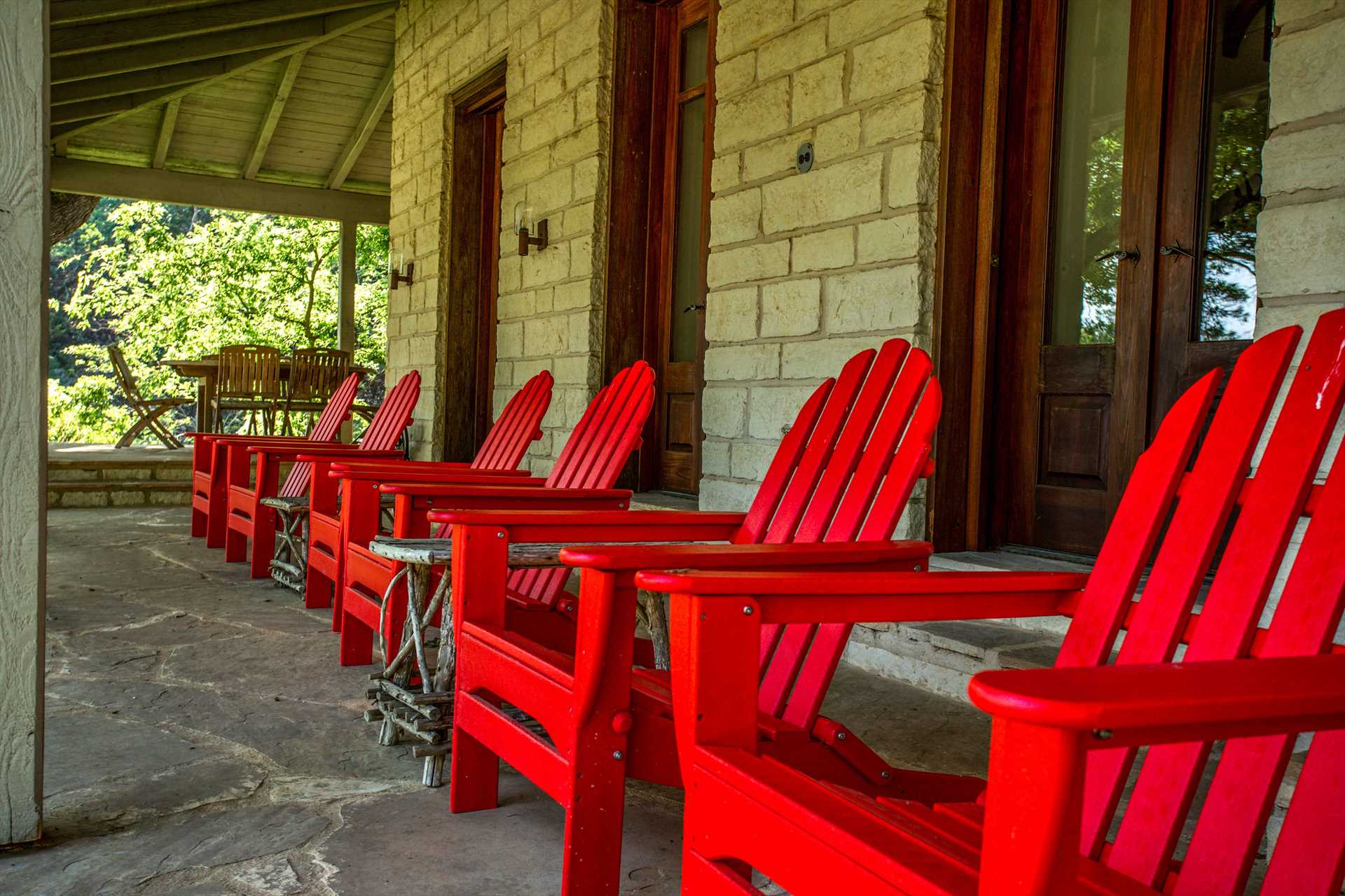                                                 Colorful Adirondack chairs on the Homestead patio provide a perfect perch for wildlife watching and taking in the Hill Country views!