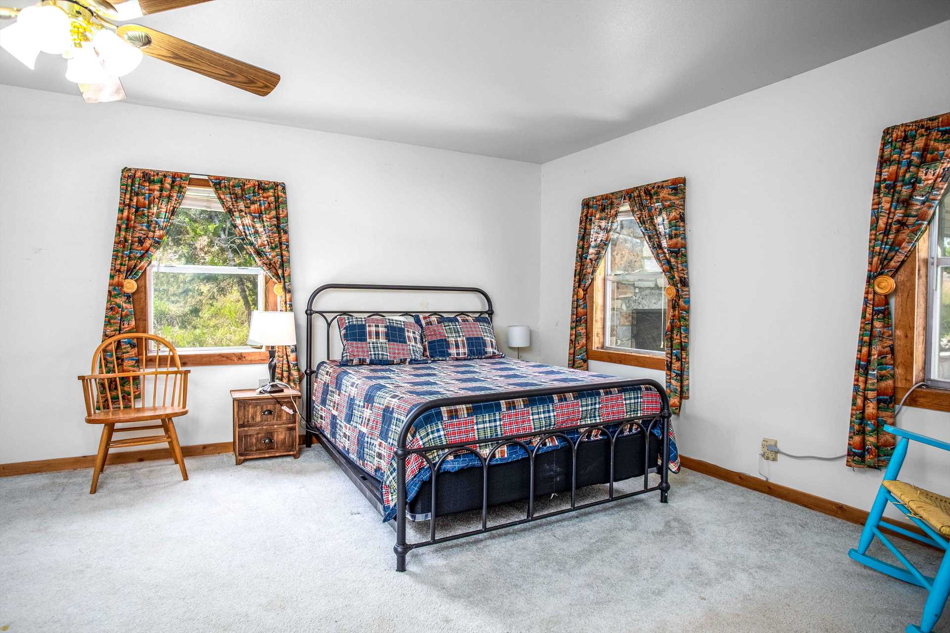                                                 The roomy second bedroom in the Hill House includes a plush and comfy star-spangled queen-sized bed!