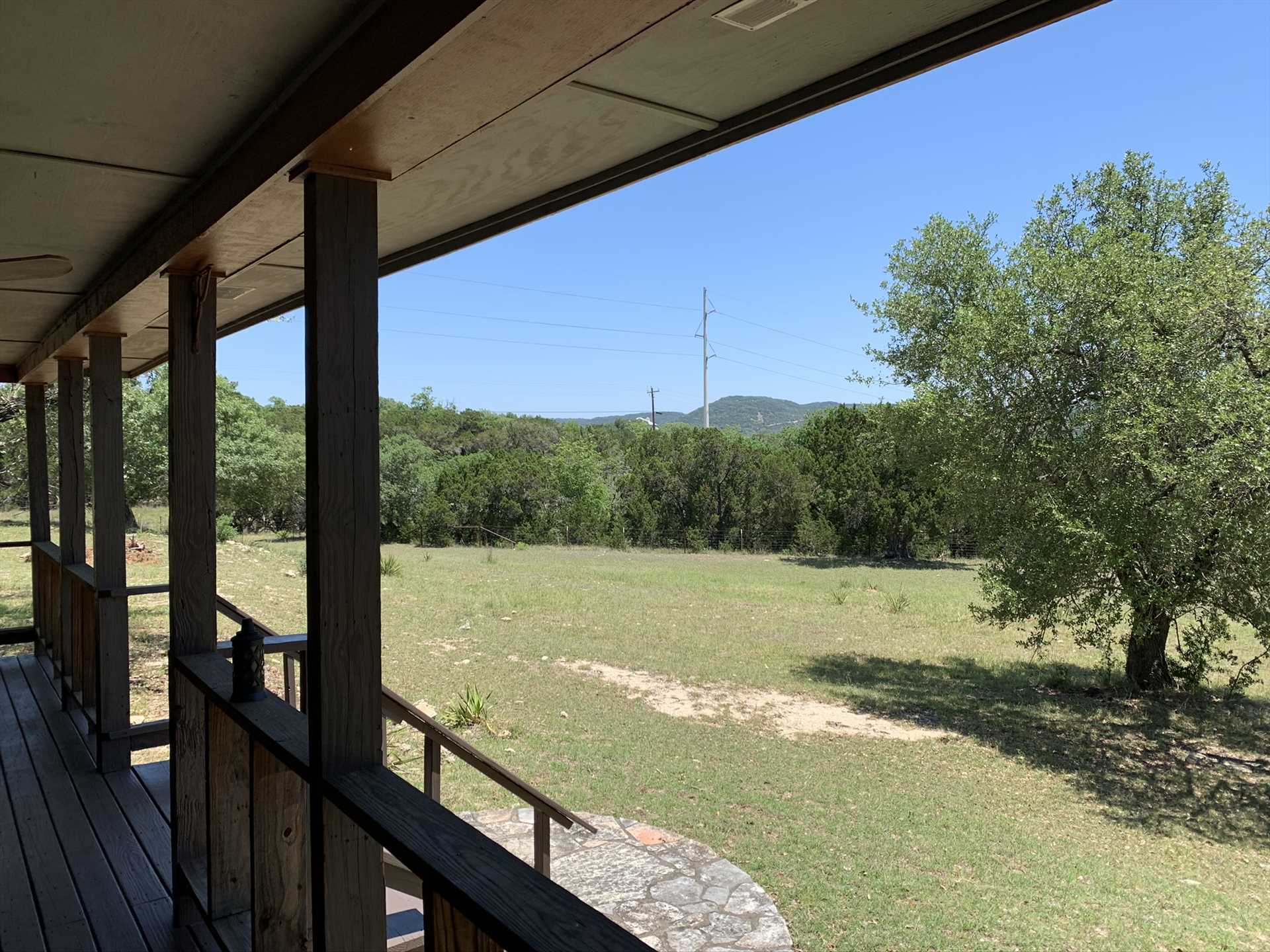                                                 No matter the time of year, or the time of day, the view from the shaded porch shows off the very best of the Texas Hill Country.