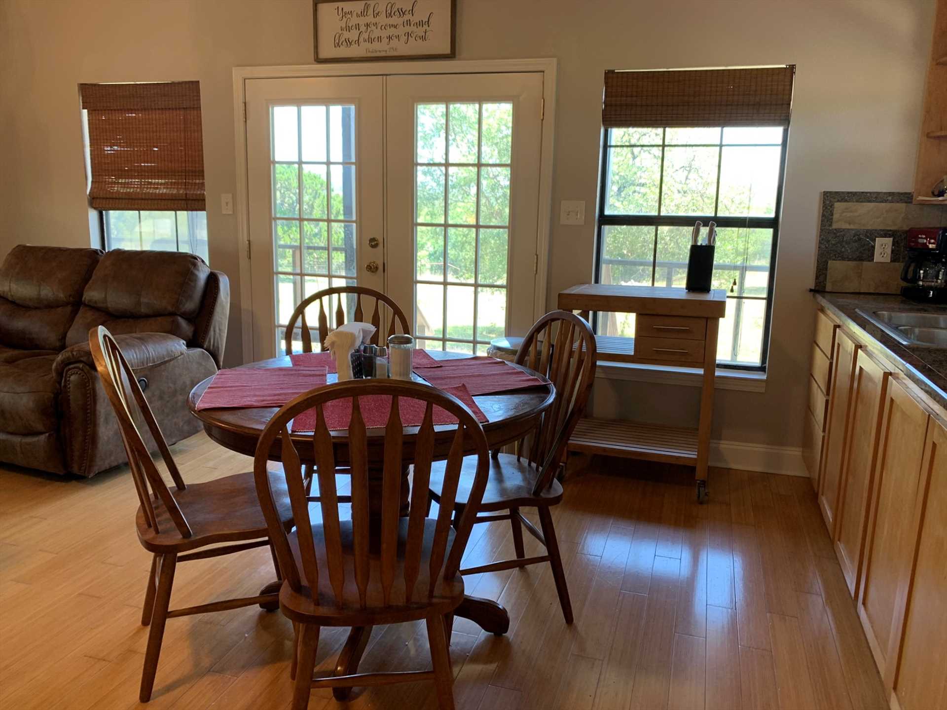                                                 Seating up to four, the dining room table is positioned right by windows and French doors for a beautiful view of the great outdoors.