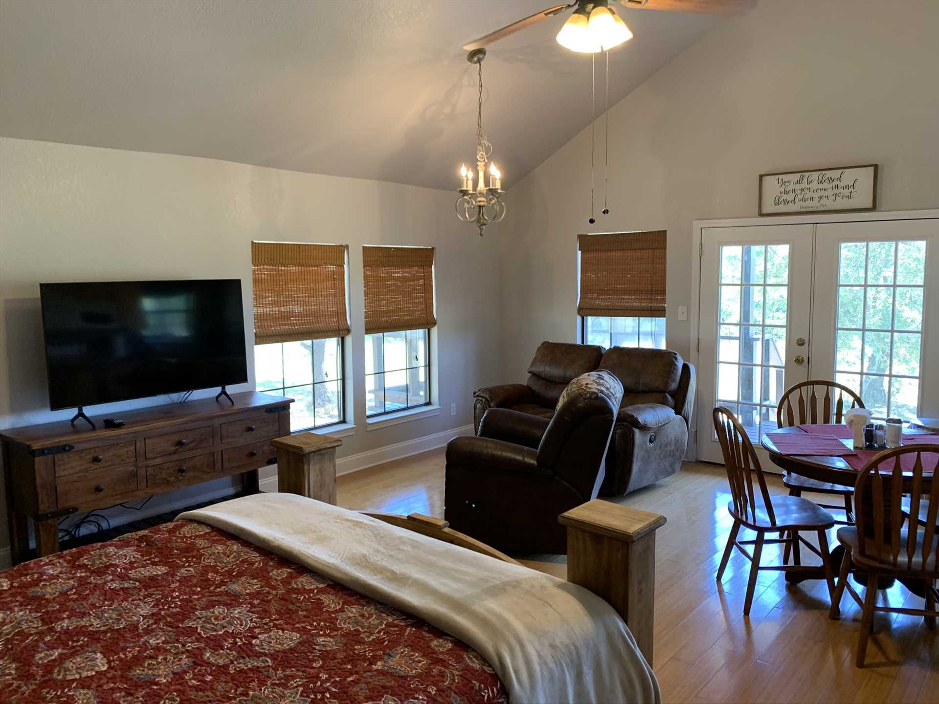                                                 The open-floor plan of the cabin allows the French doors and windows to fill the space with warm natural light.