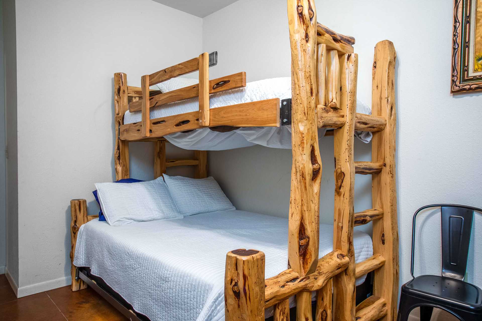                                                 Here's a closer look at one of the full/twin bunk bed setups. They comfortable sleep two people below, and one above.