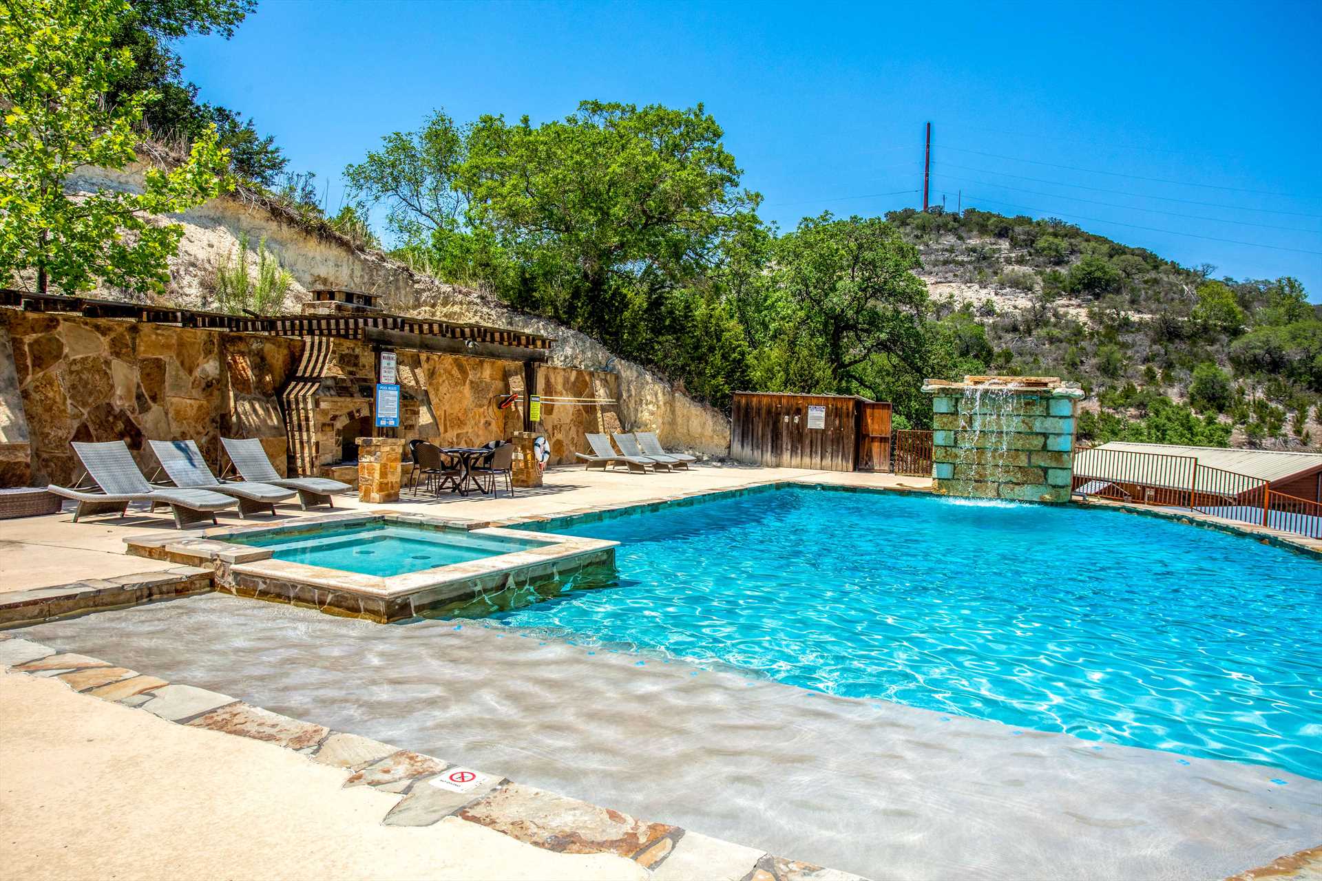                                                 Here's where you beat the Texas heat! The pool includes a waterfall feature and separate hot tub.