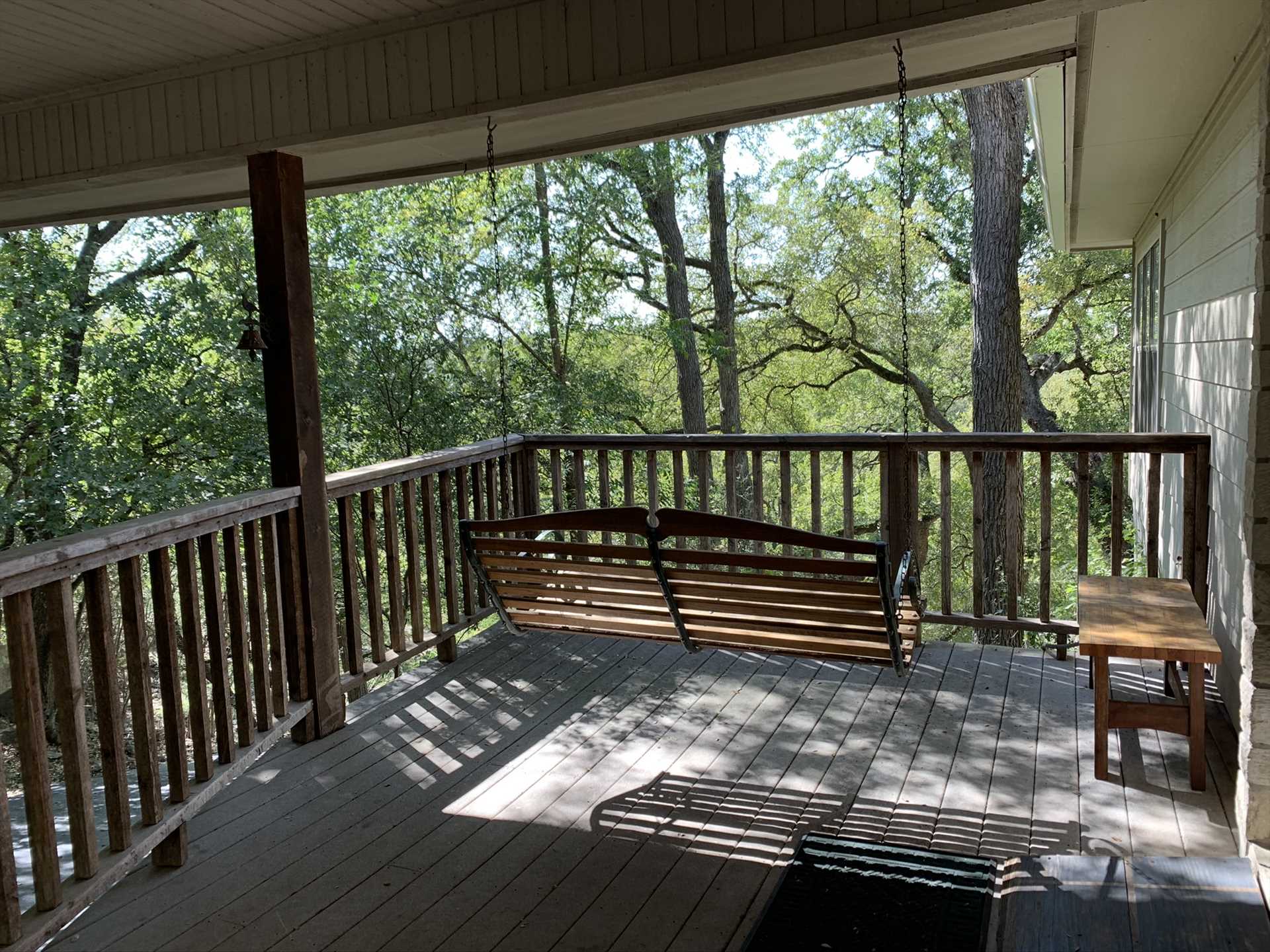                                                 The side patio has a porch swing that provides a more intimate relaxation space.