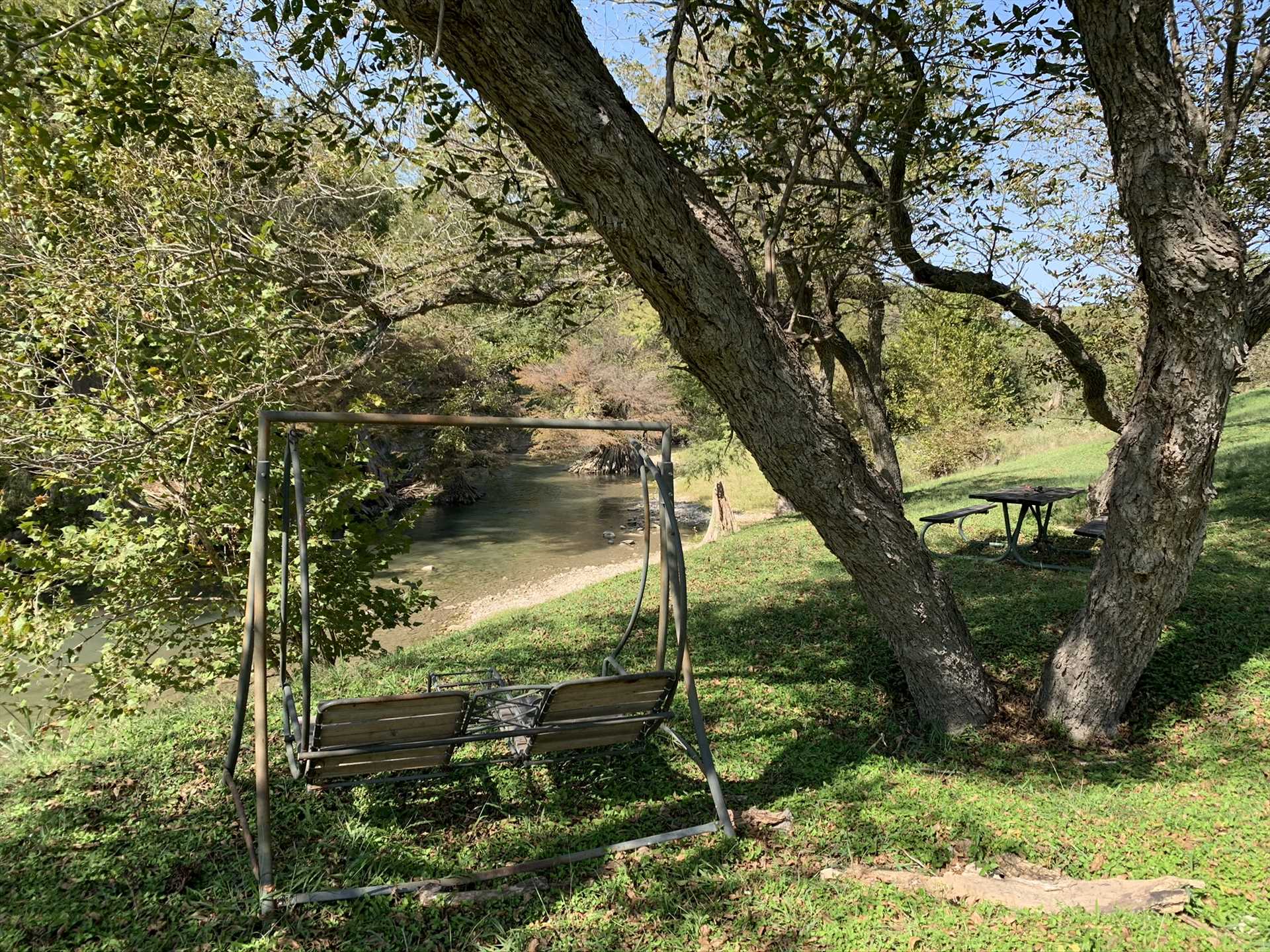                                                 Swing in the shade with that special someone! It's a great place to sip a glass of Texas wine alongside the peaceful river.