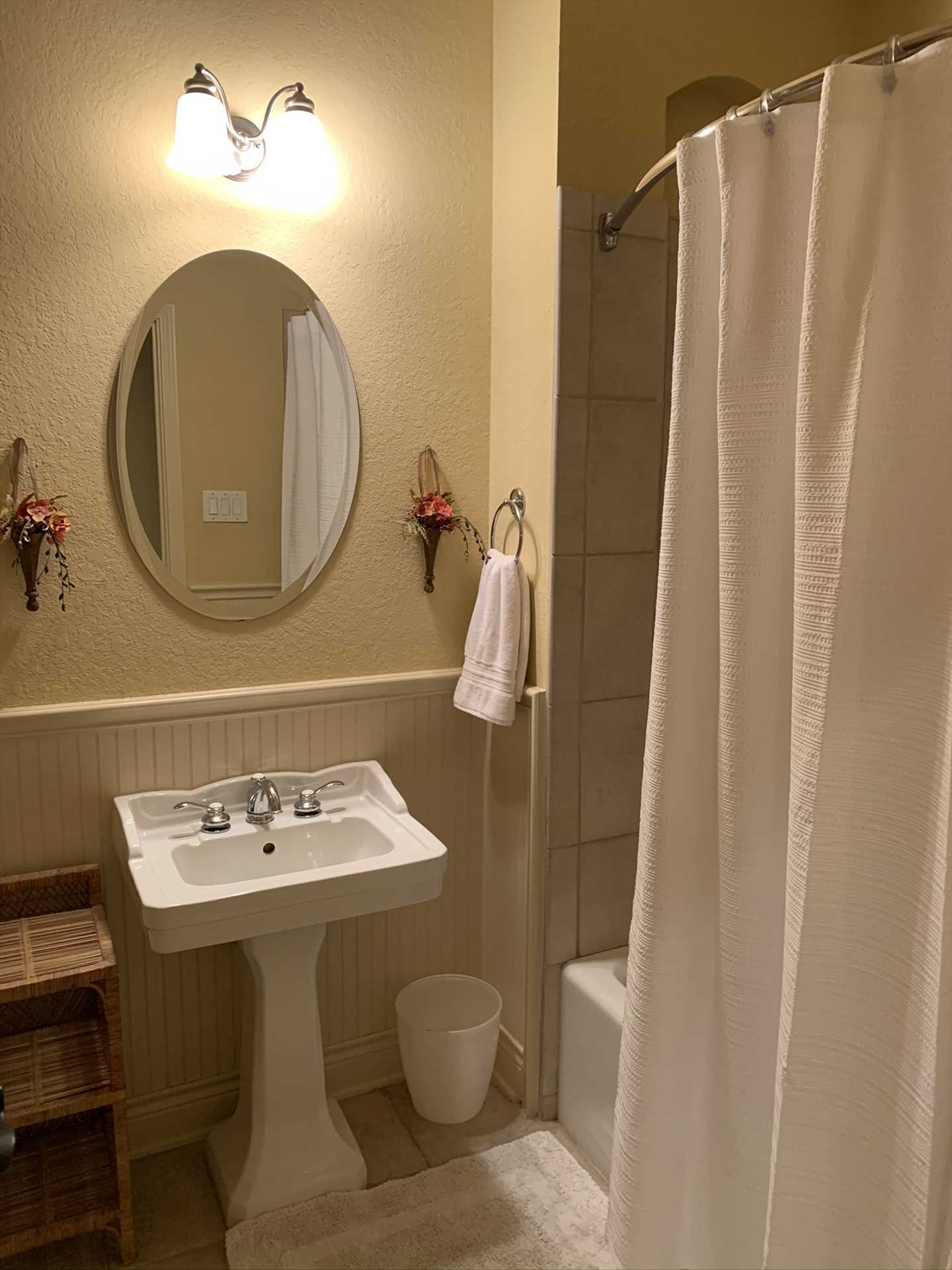                                                 A second full bath, with a shower and tub combo, is located in the hallway convenient to the second and third bedrooms.