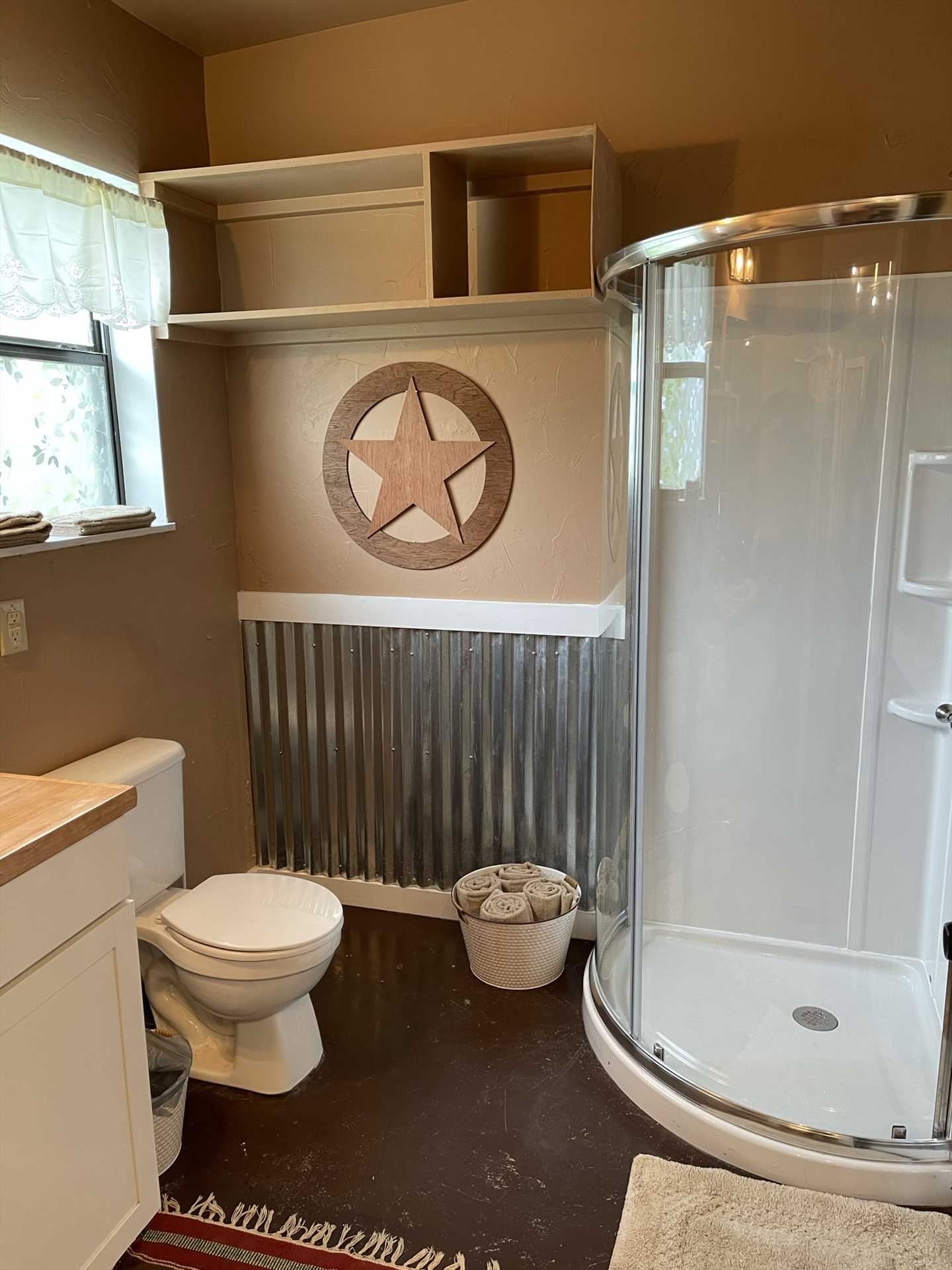                                                 A modern and unique circular shower stall is the centerpiece of the full bath at the Retreat.
