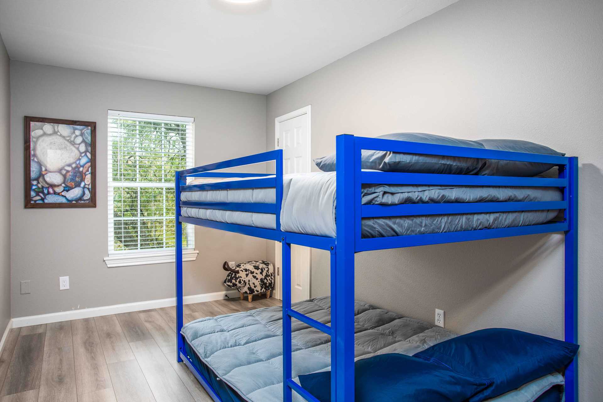                                                 The third bedroom features fun and stylish full-sized bunk beds! Please keep in mind the upper bunk is for kids only.