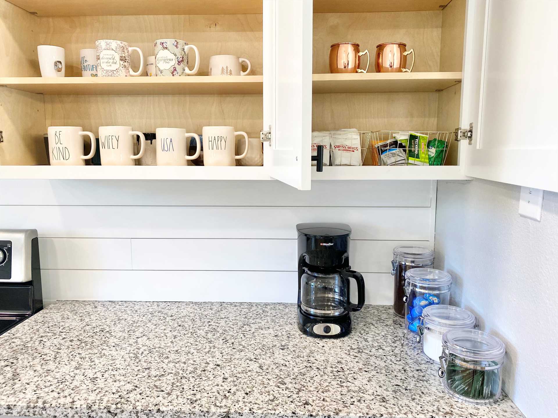                                                 Coffee, tea, hot chocolate, and cups are provided for those all-important morning pick-me-ups. There's also plenty of cookware, utensils, and serving ware here.