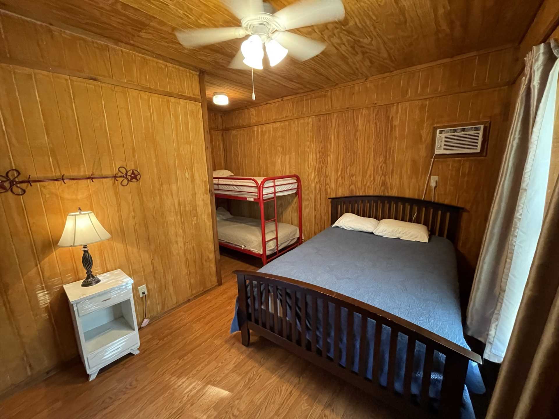                                                The two cozy bedrooms in the Gone Fishin' Cabin provide comfy slumber for up to six of your folks.