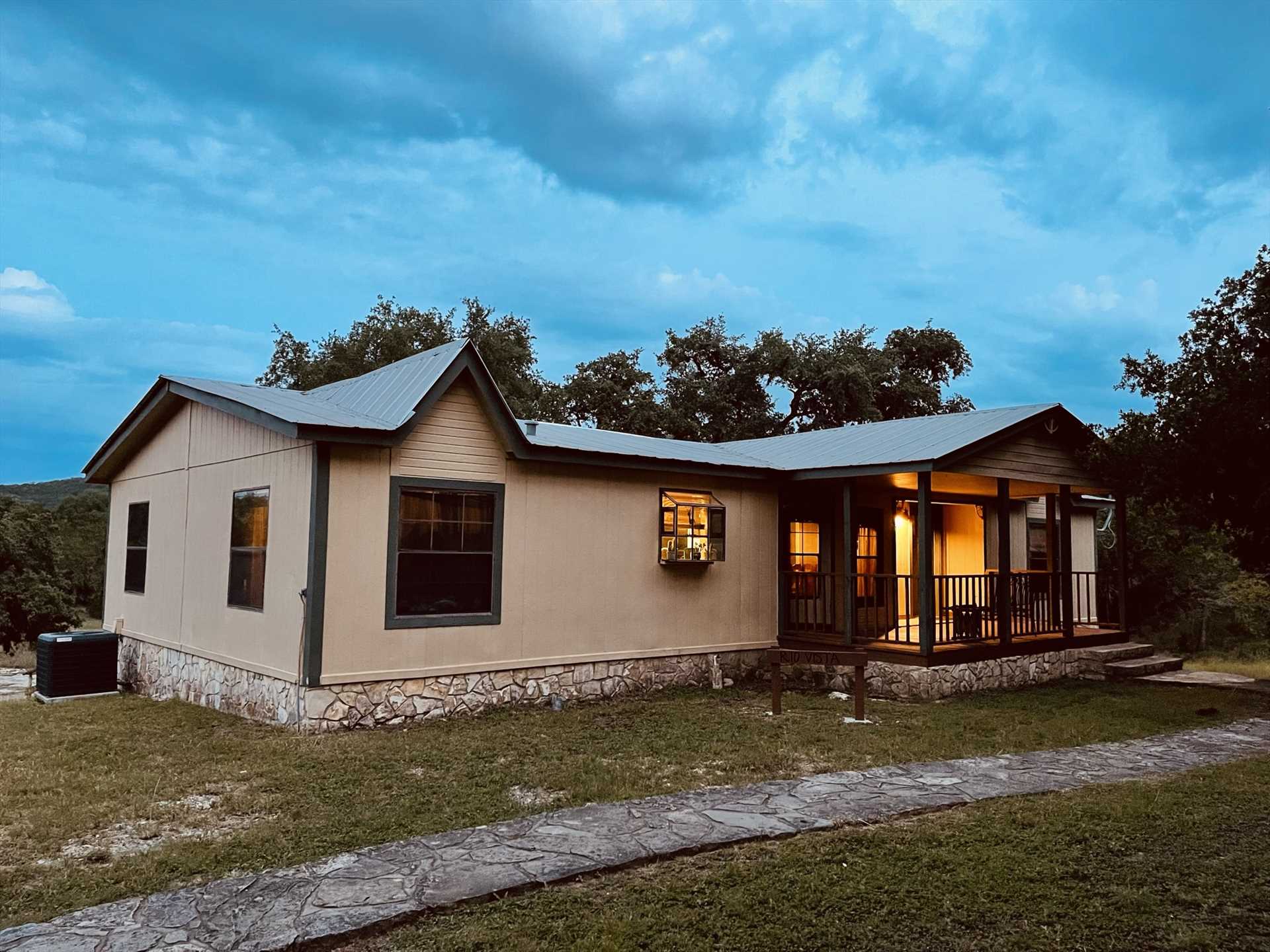                                                 A cozy front porch, an enormous deck out back, and a charcoal grill are just some of the outdoor amenities you'll enjoy at Rio Vista the second of six guest quarters at the Retreat!