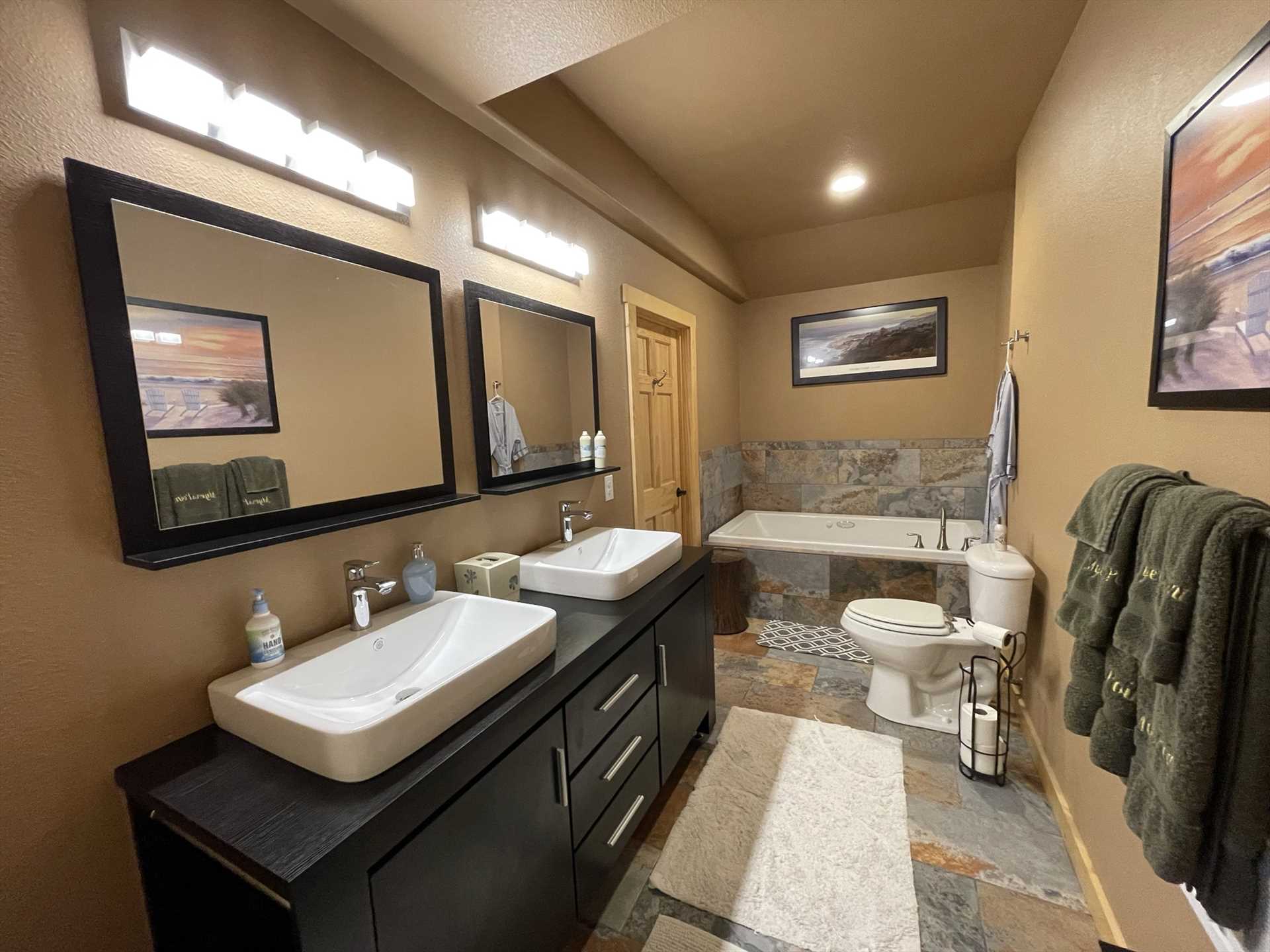                                                 Modern decor and twin vanities highlight the first bathroom at Bandera Ridge-not to mention a roomy and relaxing Jacuzzi tub!