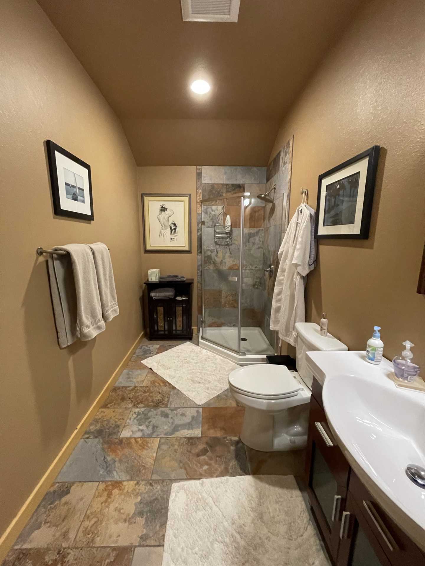                                                 A sparkling and unique shower stall welcomes you in the second bathroom-and fresh linens are included in both baths.