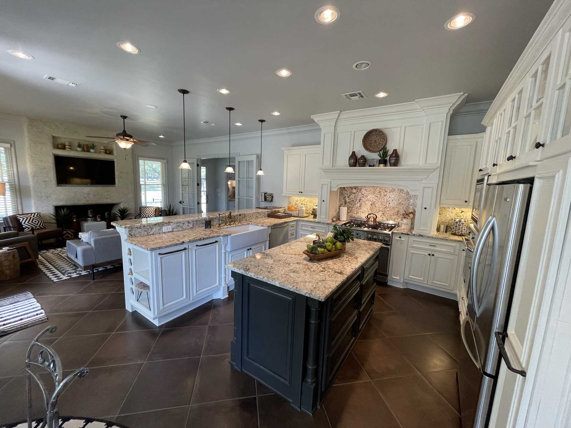                                                 A massive central island, tons of counter space, and gleaming modern appliances make the kitchen a wonderful space for the cooks in your crew!