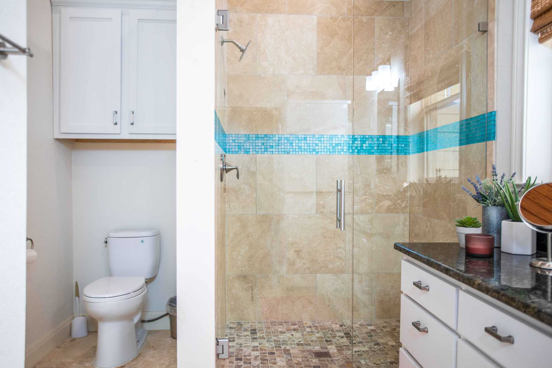                                                 The immaculately-clean full bath features a stylish and roomy tiled shower...and bath linens are provided here, too!