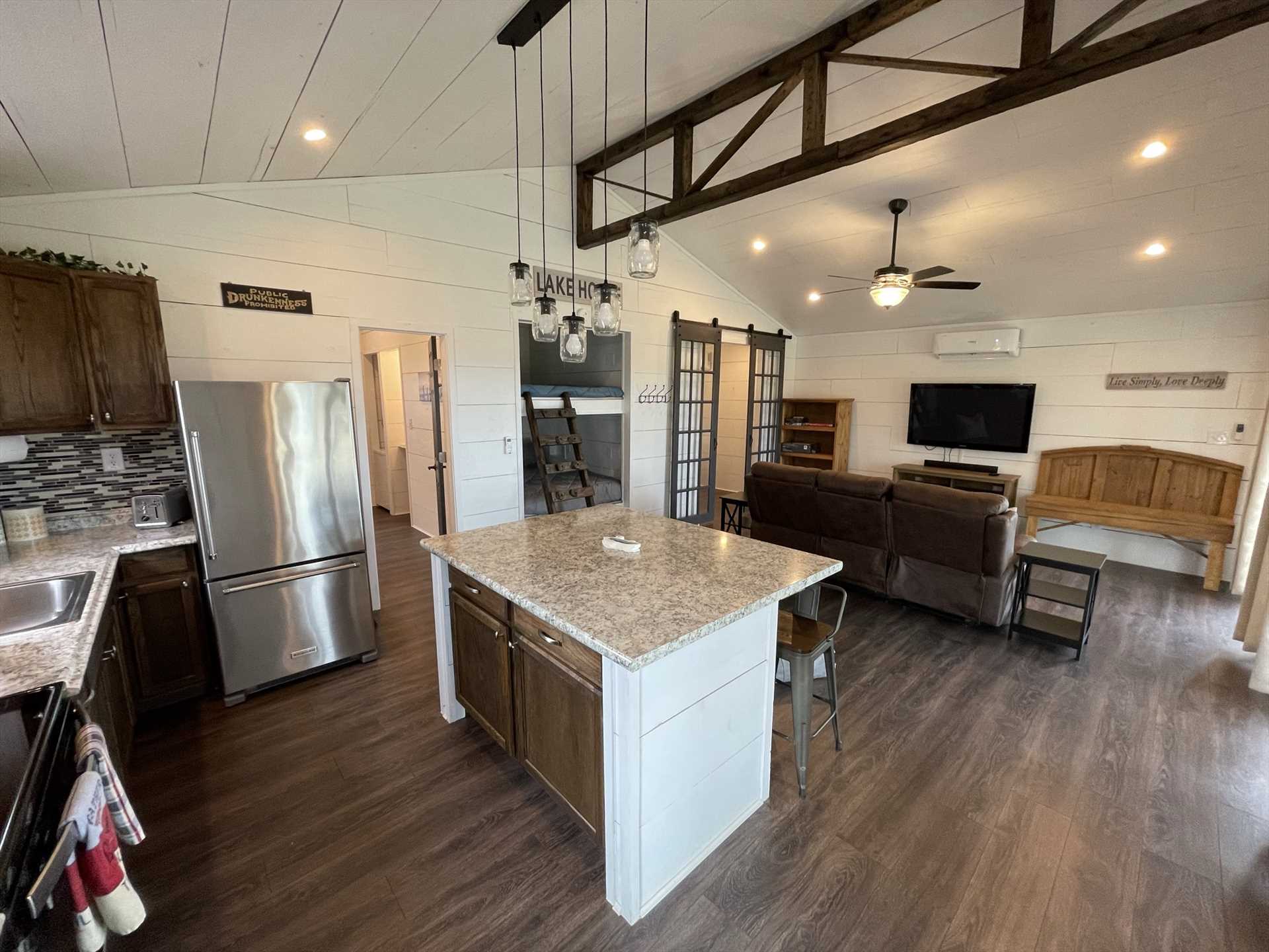                                                 A wide-open floor plan allows for conversation and laughter between the kitchen, dining area, and living space!