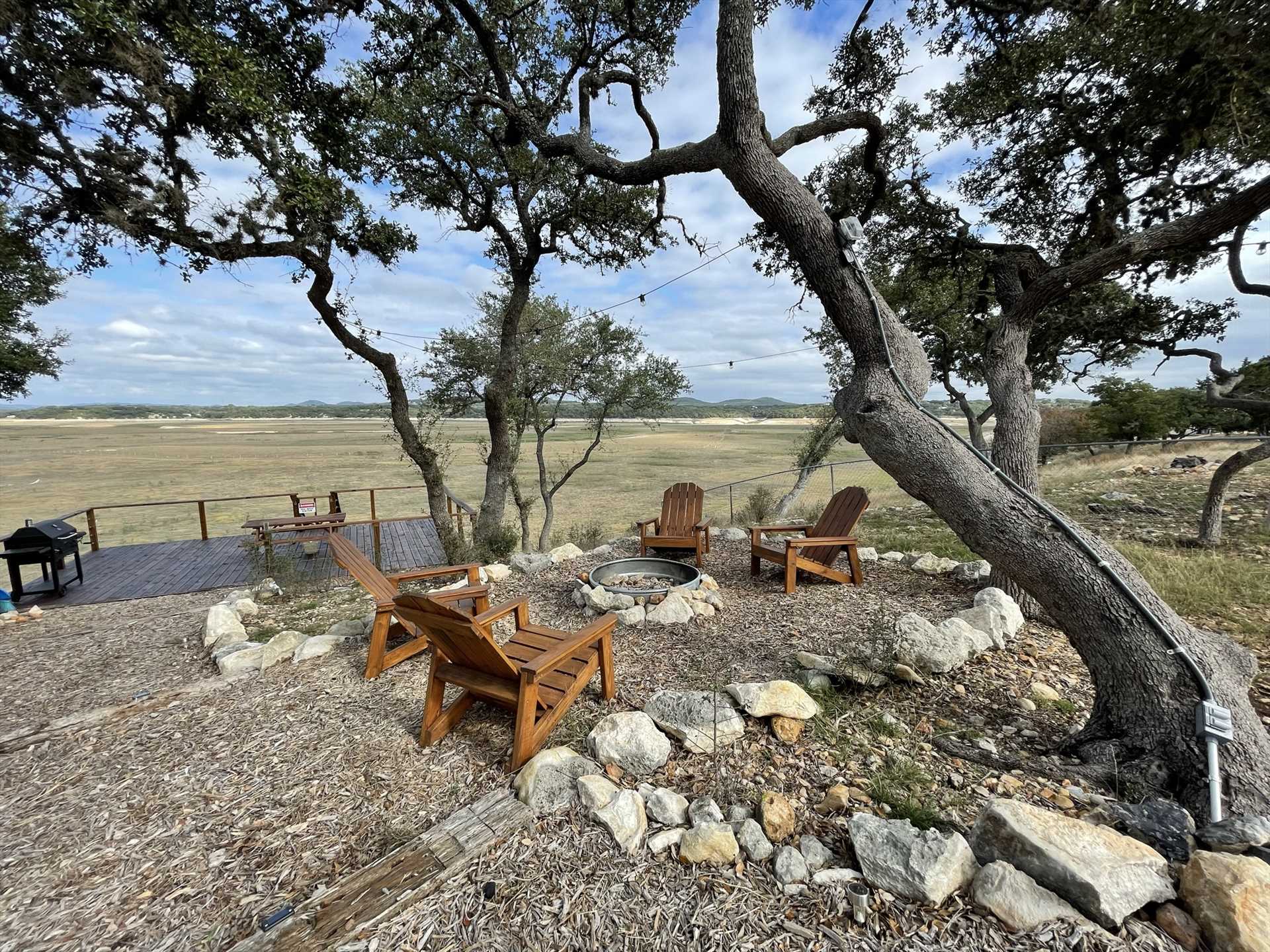                                                 Adirondack chairs surround the fire pit at the Hill Country Roost, giving you a panoramic window to the sunsets, starry skies, and mountain views!