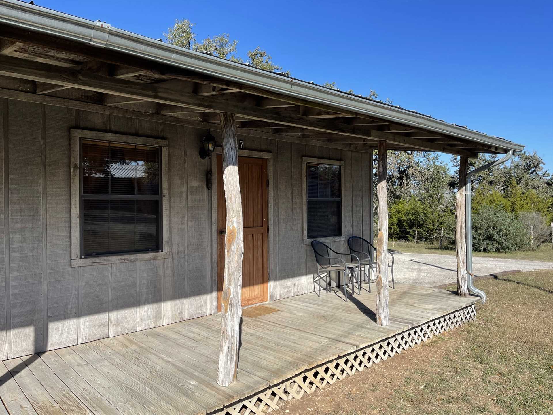                                                 Tree trunk columns highlight the shaded deck here, where you'll have fantastic views of the ranch and Hill Country!